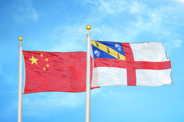 China and Herm two flags on flagpoles and blue cloudy sky