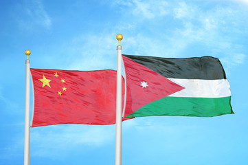 China and Jordan two flags on flagpoles and blue cloudy sky