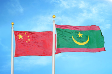China and Mauritania two flags on flagpoles and blue cloudy sky
