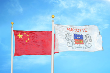 China and Mayotte two flags on flagpoles and blue cloudy sky