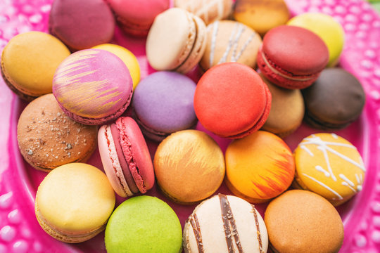 Many macarons closeup on table. Numerous colorful french macaron pastries.