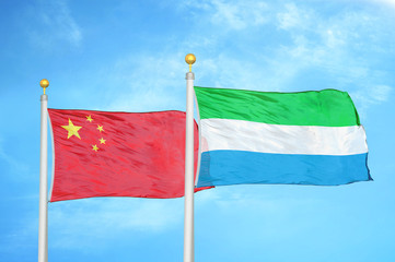 China and Sierra Leone two flags on flagpoles and blue cloudy sky