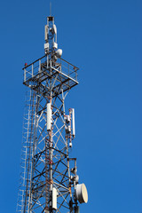 Telecommunication tower against blue sky