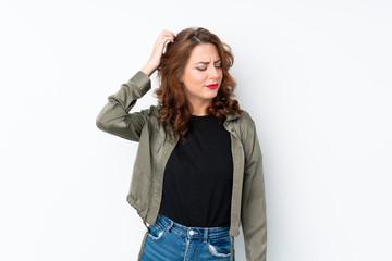 Young Russian woman over isolated white background having doubts while scratching head