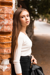 A young girl walks around the city, street photo,, the concept of a pedestrian walk. urban tourism concept,