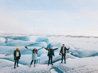 Two couples walking on a glacier in Solheimajokull, Iceland