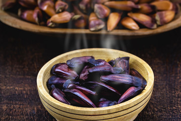 pine nuts cooked with shell. pine nut seed on rustic wooden table. Brazilian cuisine, consumed in the winter and June parties.