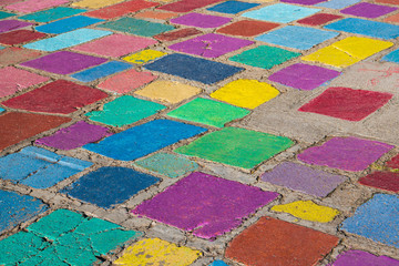 Rustic concrete tiles in brilliant colors of purple, green, blue, and red