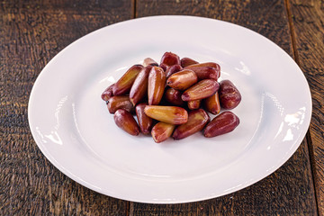 pine nut seed cooked and isolated over white background. Healthy and exotic Brazilian cuisine.