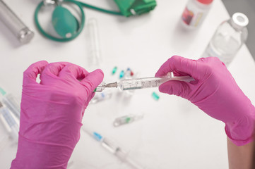 Fototapeta premium The nurse prepares for the medical procedure by filling the syringe