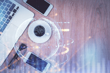 Double exposure of map hologram drawing over desktop. Top view. International connection concept.