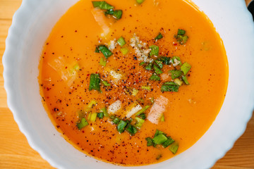 plate with traditional borscht (beetroot soup) on wooden table.