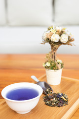 cup of tea with spoon of herbs 