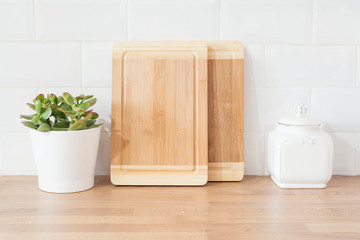 Bright And Clean Modern Minimalist Kitchen, Close Up. Cutting Boards, Green Succulent Pot On A...