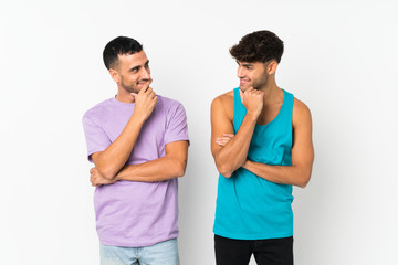 Two men over isolated background looking looking at each other