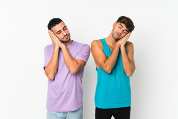 Two men over isolated background making sleep gesture in dorable expression
