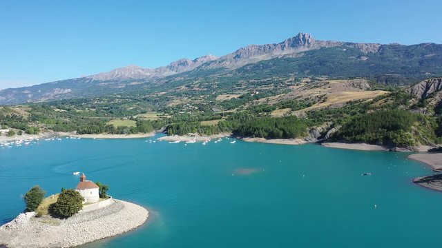 Serene summer landscape of Lake Serre-Poncon, artificial lake surrounded by French Alps, Provence-Alpes-Cote d Azur region