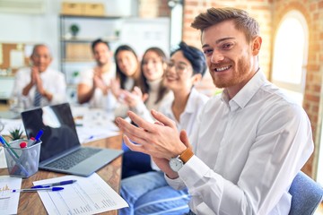 Group of business workers smiling happy and confident. Working together with smile on face looking at the camera applauding at the office