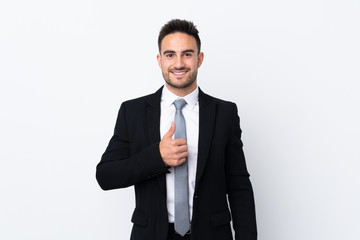 Young business man over isolated background giving a thumbs up gesture