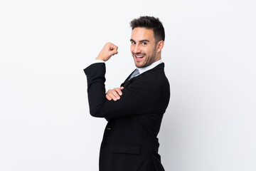Young business man over isolated background making strong gesture