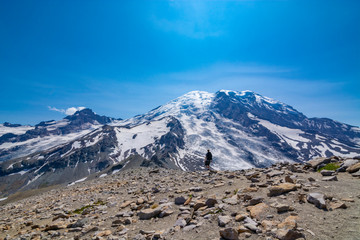 Fototapeta na wymiar Adventurous man hiking near Mount Rainier.