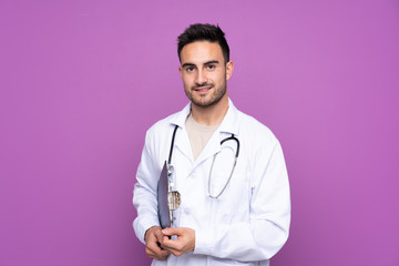 Young man wearing a doctor gown and holding a folder