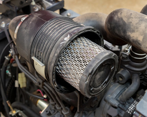 Air filter on diesel lawn mower tractor engine. Concept of small engine repair, service and...