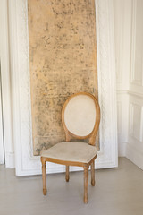 Beautiful vintage, soft chair in a light interior. Chair on the background of the picture.