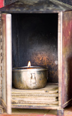 A prayer candle burns in a buddhist monastery in China.