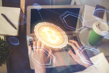 Double exposure of woman hands typing on computer and crypto market theme hologram drawing....