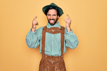 Young handsome man wearing tratidional german octoberfest custome for Germany festival shouting...