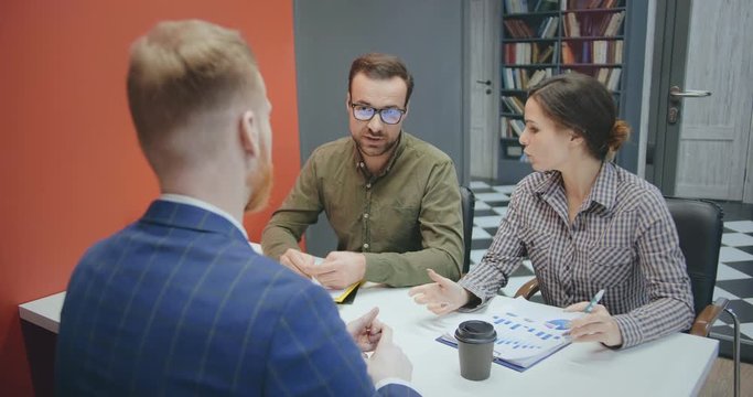 Back view of male applicant during job interview with employers