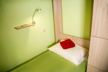 Beautiful interior of a cozy hostel. Bunk beds in light green tones.