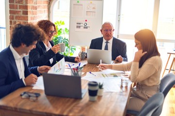 Group of business workers smiling happy and confident. Speaking with smile on face working together at the office.