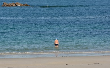 Retired man who is taking a bath in the sea in Brittany. France