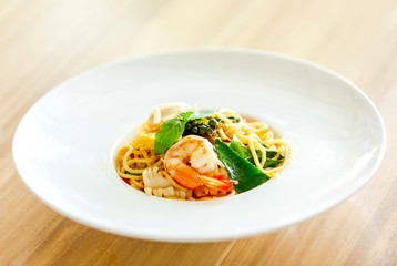 Spaghetti with seafood on white plate