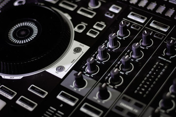 Fototapeta na wymiar Close-up jogwheel Studio Recording Equipment DJ Controller Mixer with faders & knobs 