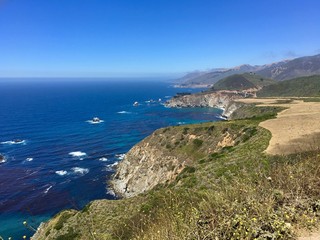Fototapeta na wymiar California coastline south of Monterey with a brilliant blue Pacific Ocean and sharp cliffs. 