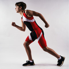 Young teenage track athlete running pose