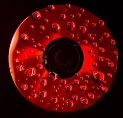 red cd with water drops on it