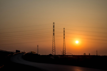 Sunset on the background of the road and antennas. Beautiful landscape. Background.