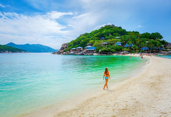 Woman on the sand beach on tropical island in Thailand