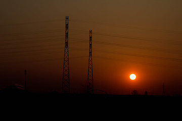 Fototapeta premium Sunset on the background of the road and antennas. Beautiful landscape. Background.