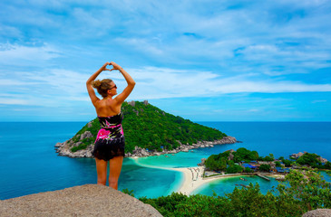 Young woman at viewpoint over beautiful tropical islands in Thailand 