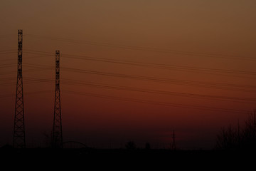 Fototapeta premium Sunset on the background of the road and antennas. Beautiful landscape. Background.
