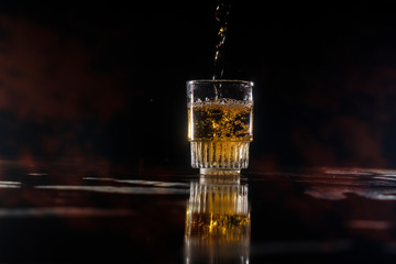 A liqueur's cup filling it up in a bar