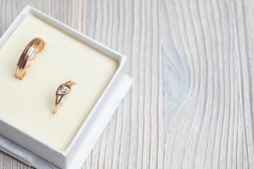 Wedding rings on a wooden table.