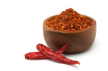 Cayenne pepper in a wooden bowl and dried chilli isolated on white background,copy space.	
