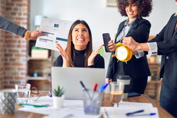 Group of business workers working together. Partners stressing one of them at the office