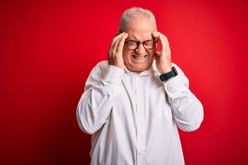 Middle age handsome hoary man wearing casual shirt and glasses over red background with hand on headache because stress. Suffering migraine.